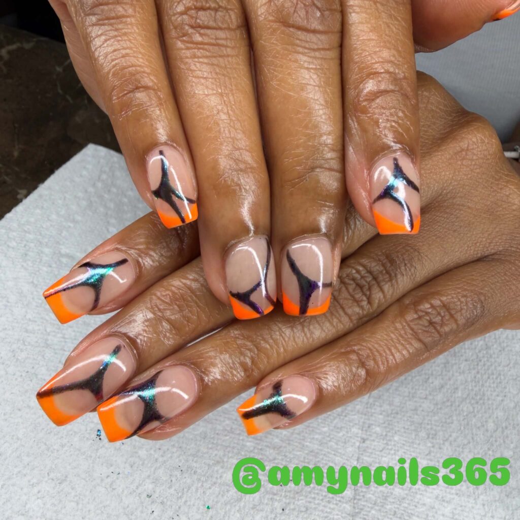 Orange and black abstract square nail art with blue accents